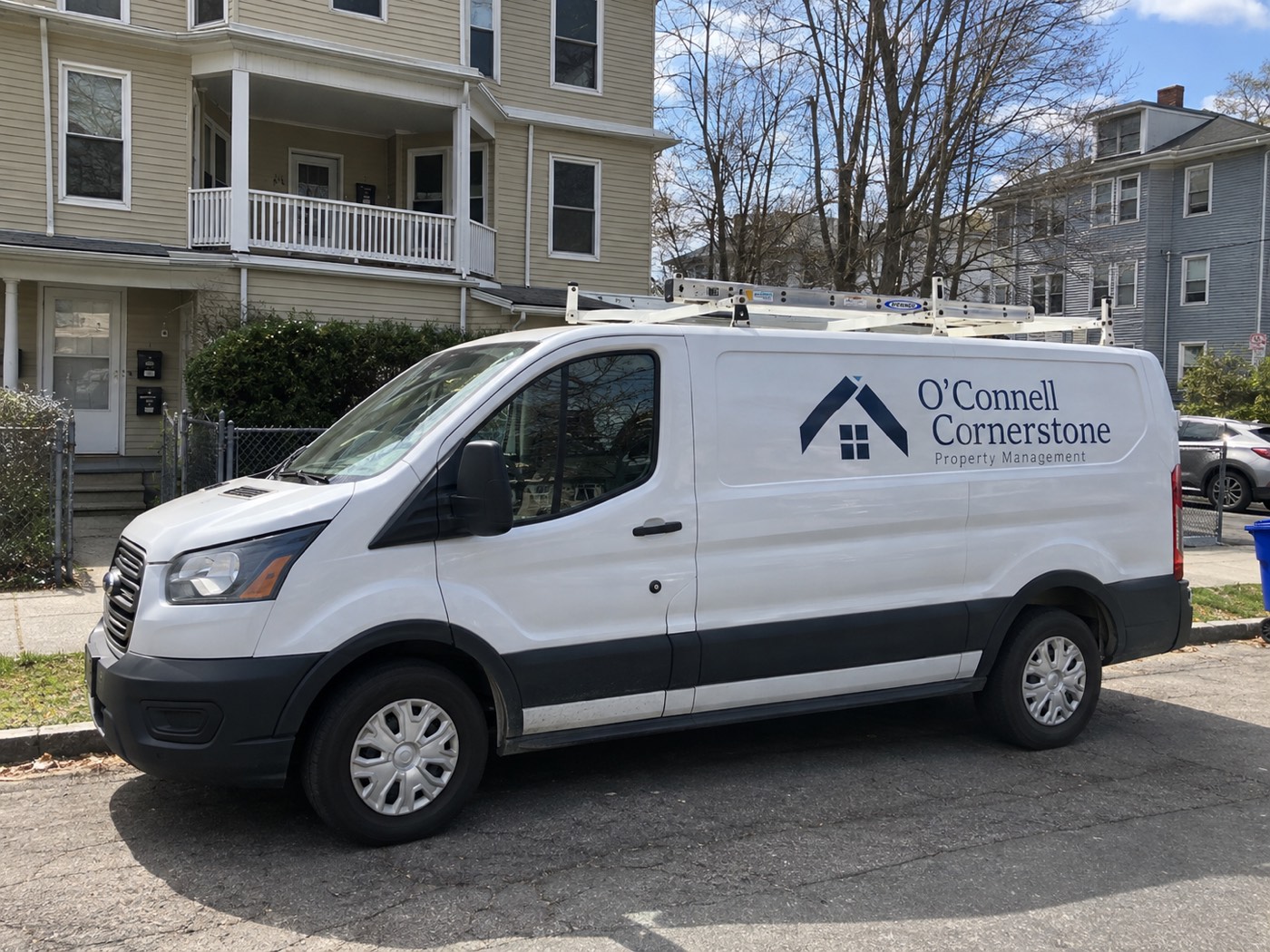 An O'Connell Cornerstone van parked outside a multifamily home in Hartford